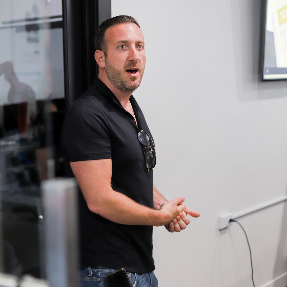 Speaker and seated guests at the Loan Goat x Change Wholesale Summit at Loan Goat HQ, photo 2