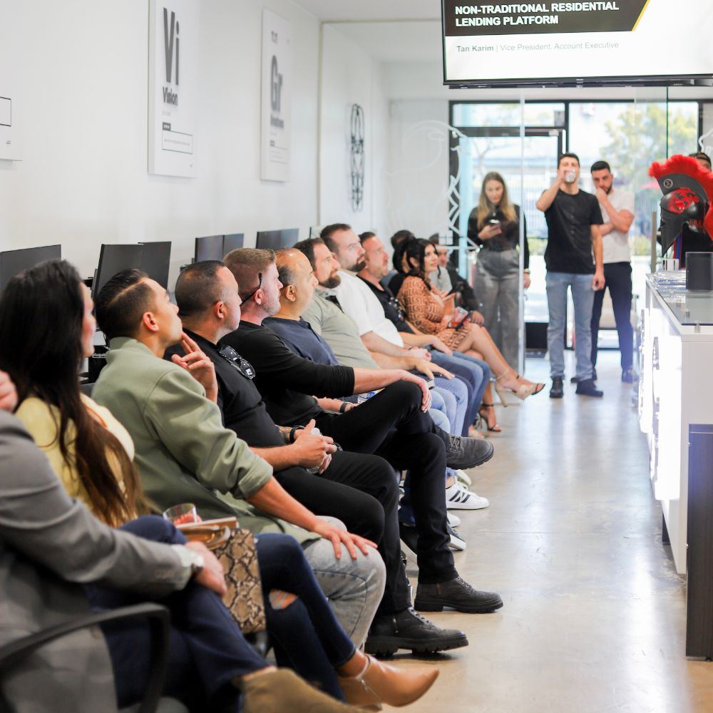 Speaker and seated guests at the Loan Goat x Change Wholesale Summit at Loan Goat HQ