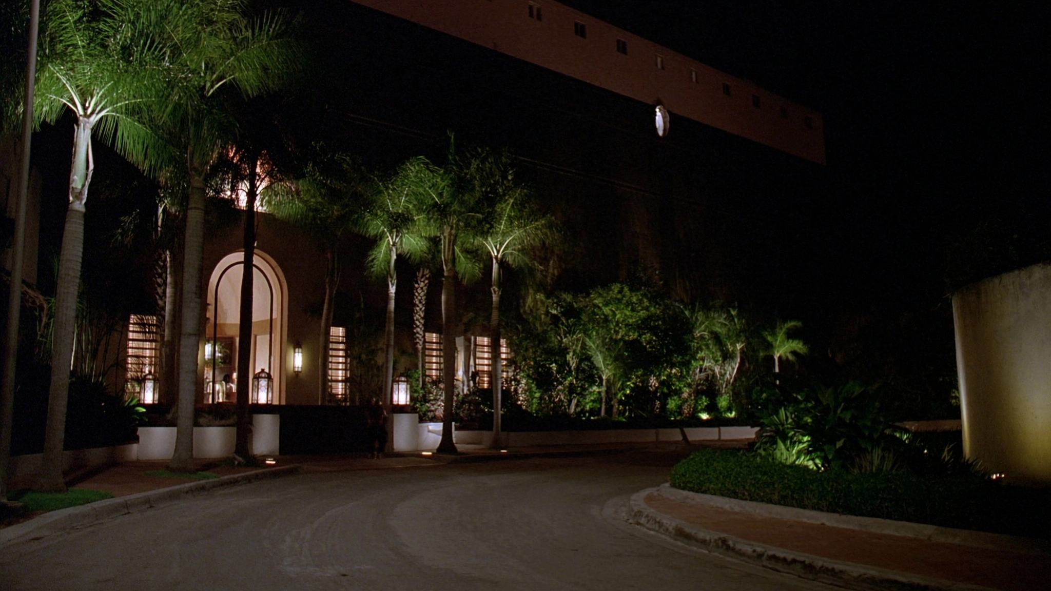 Representative photograph: Resort hotel lit at night with a pool terrace below