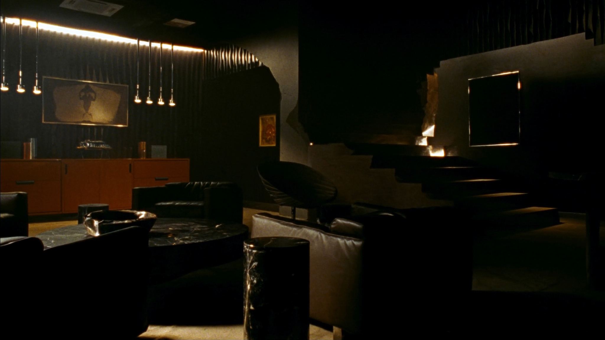 Dark lounge interior in black marble and brushed steel