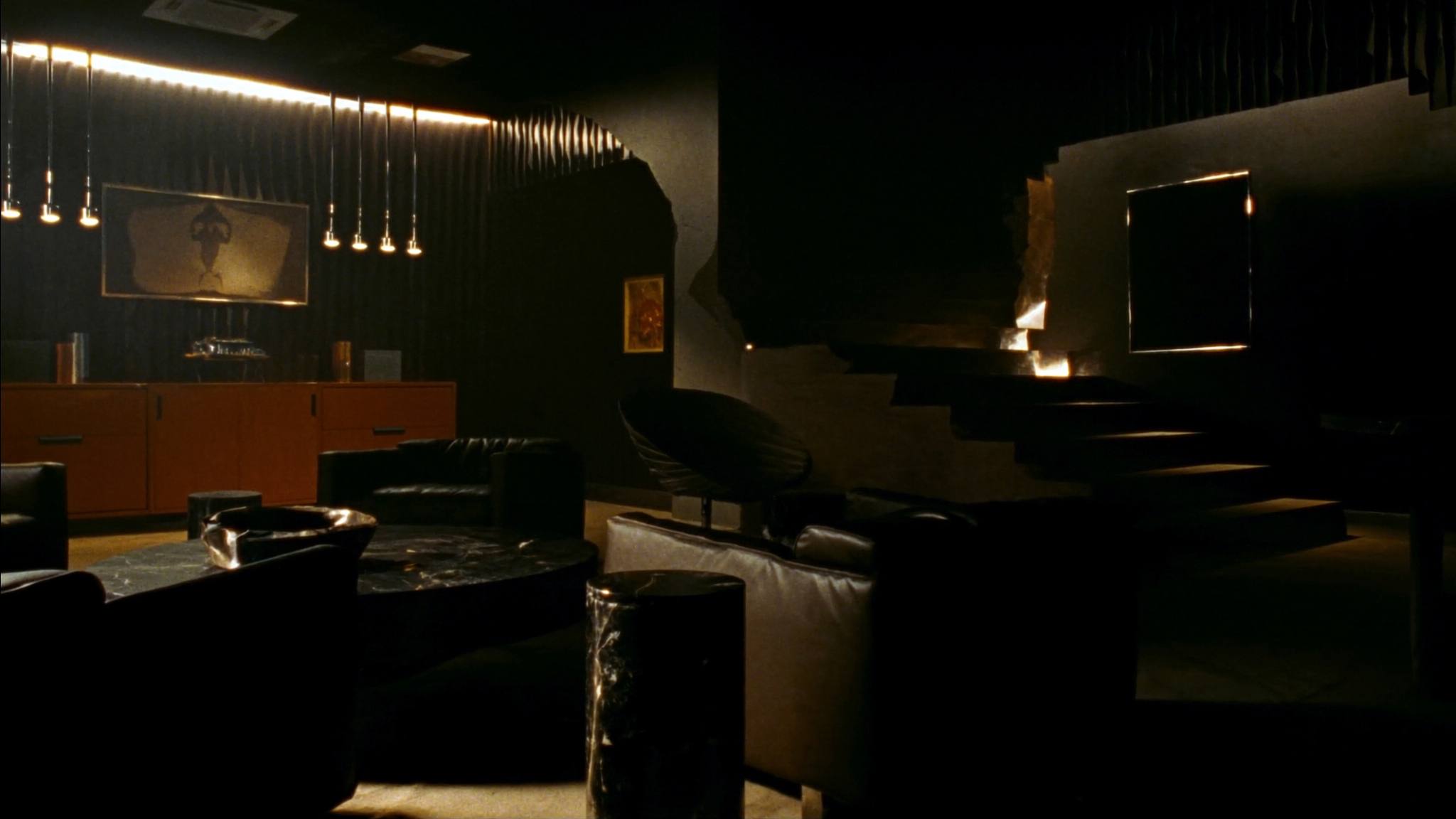 Dark lounge interior with black marble and leather seating