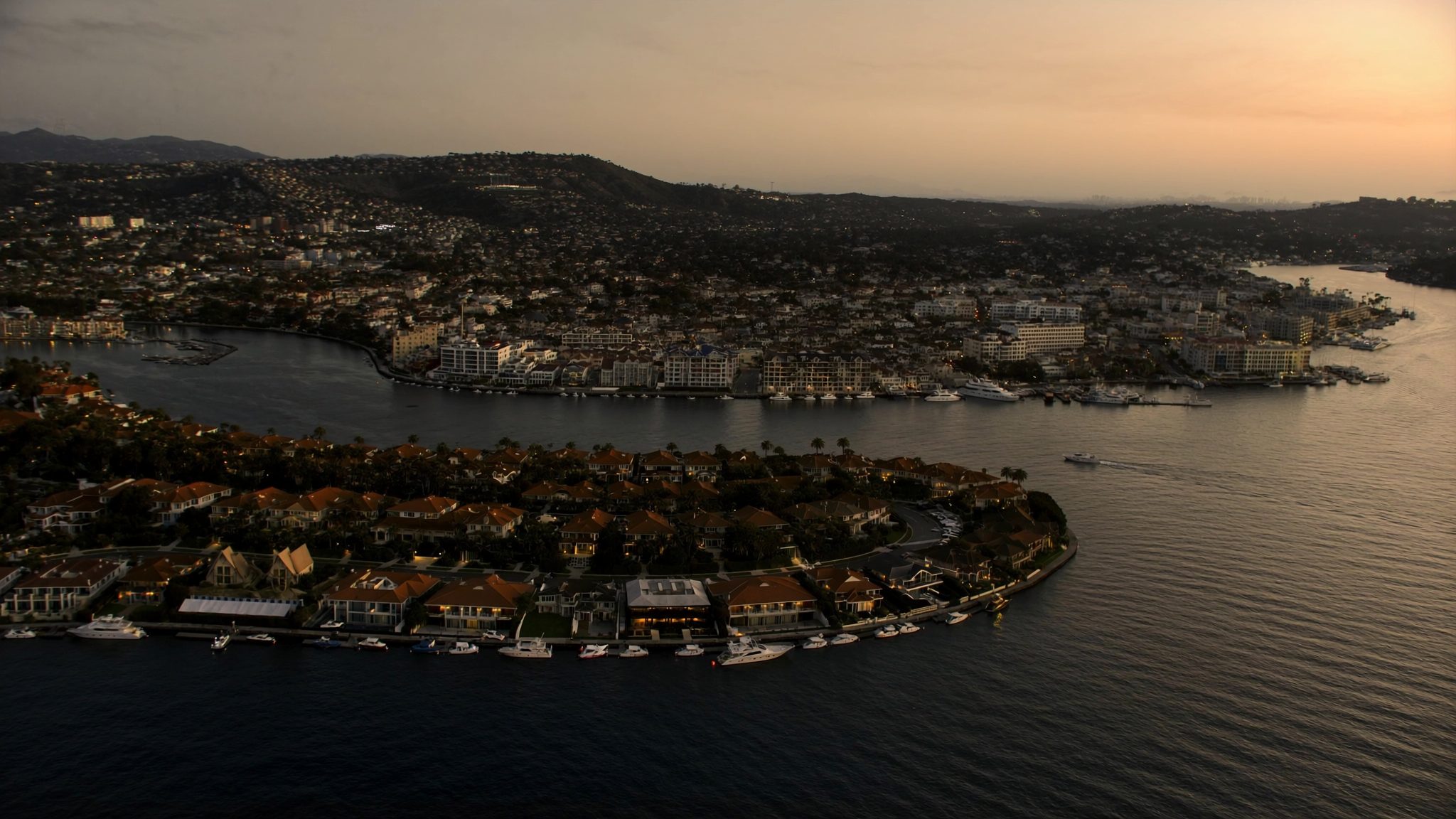 Aerial view of a Southern California harbor town at dusk
